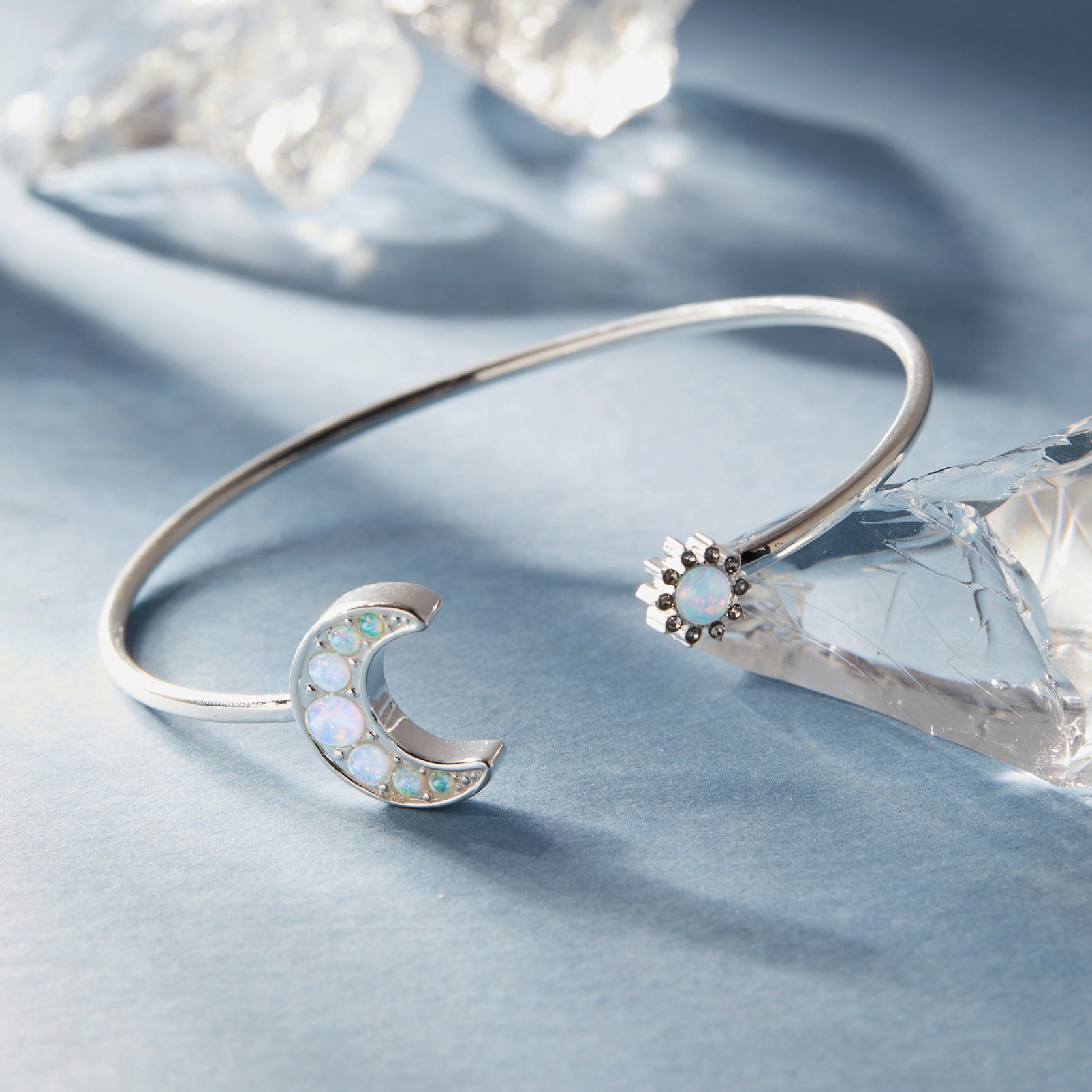 A silver sun and moon bangle bracelet