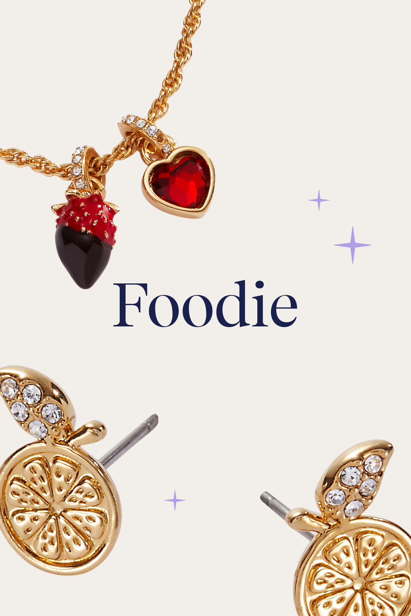 Gold jewelry set with charms and 'Foodie' text on a white background