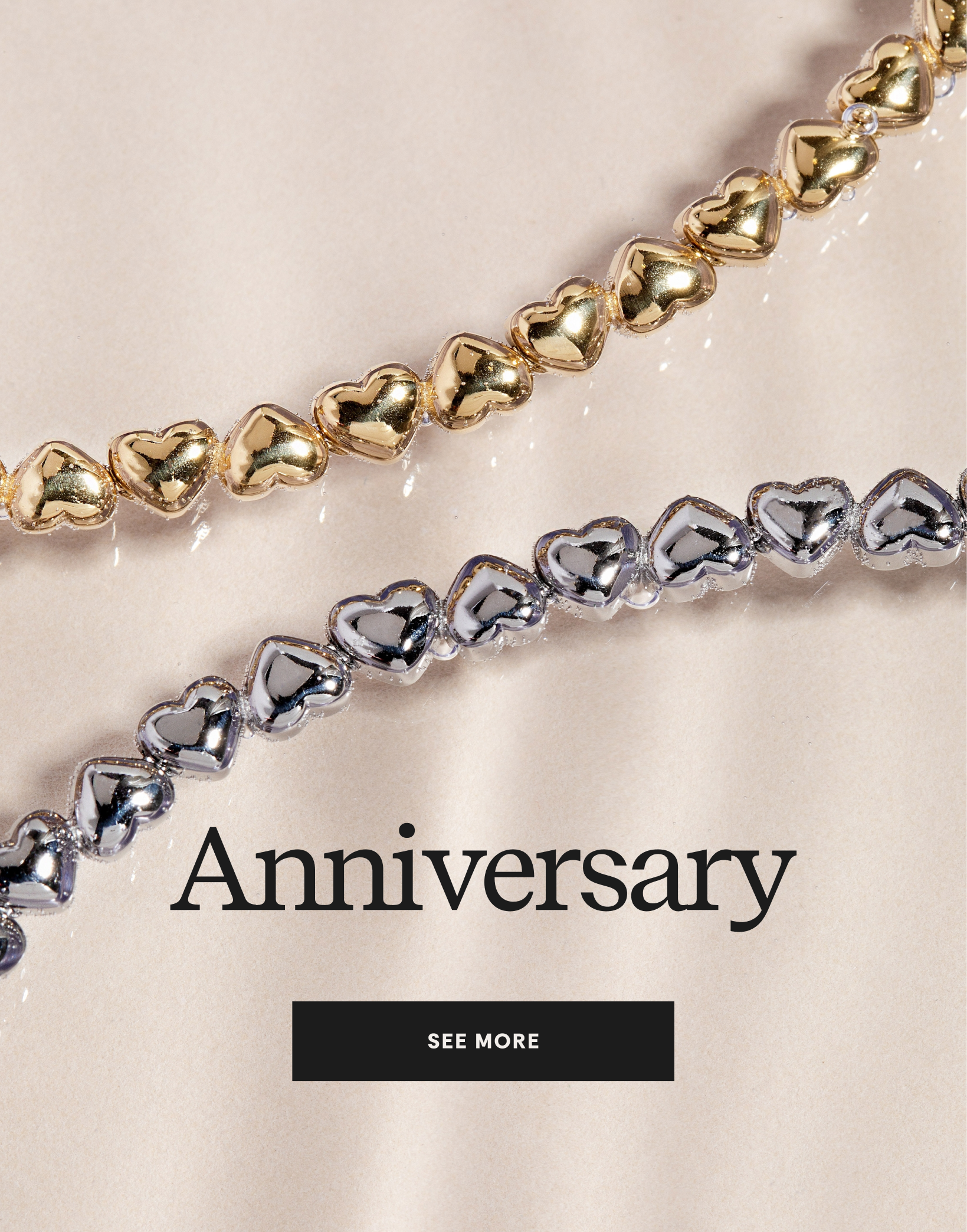 Two heart-shaped beaded bracelets, one gold and one silver, on a beige background with 'Anniversary' text.