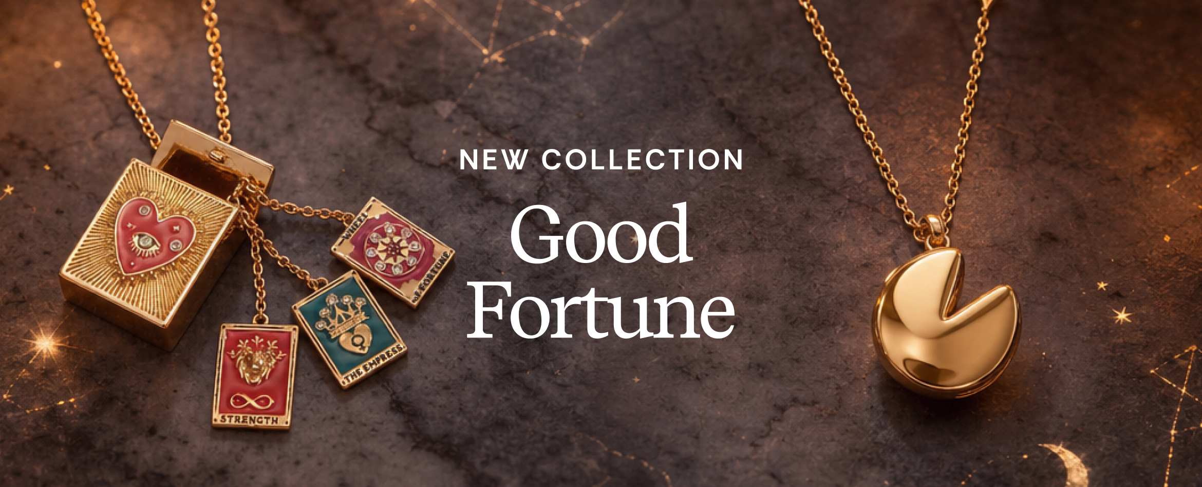 Gold-tone pendant necklaces displayed on a dark textured background with glowing star-like sparkles. The left necklace has a rectangular box pendant with a red heart and three dangling square charms with red, pink, and teal designs.