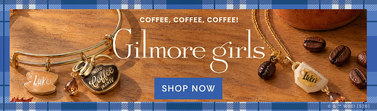 A promotional banner for Gilmore Girls featuring gold-toned bangles and necklaces with charms engraved with 'Luke', 'Coffee Run', and 'Tyler', alongside coffee beans on a wooden surface. The text reads 'COFFEE, COFFEE, COFFEE! Gilmore girls SHOP NOW'.
