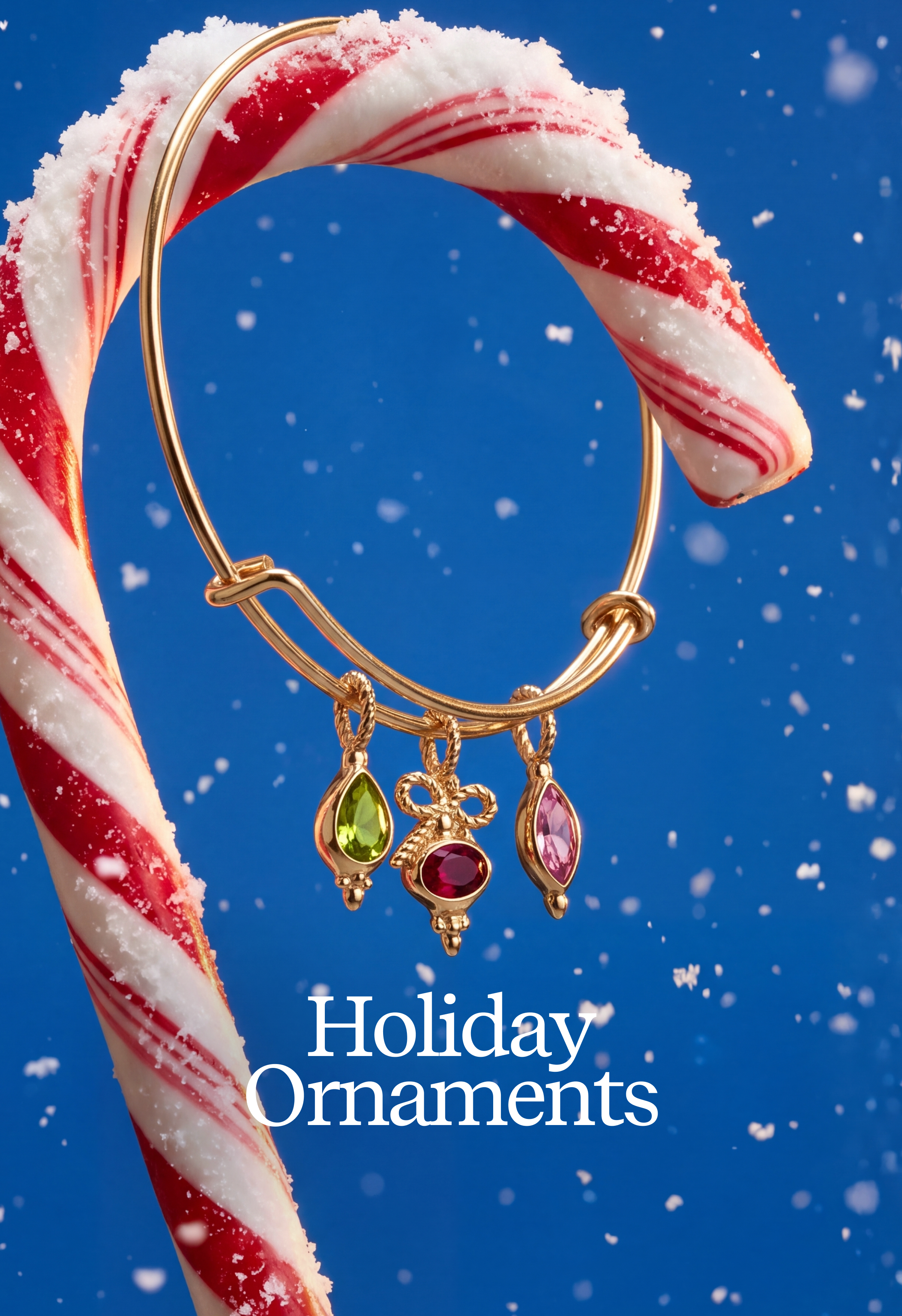 A gold-toned holiday ornament set with three dangling charms, one green, one red, and one pink, displayed on a candy cane against a blue snowy background. White text at the bottom reads 'Holiday Ornaments'.