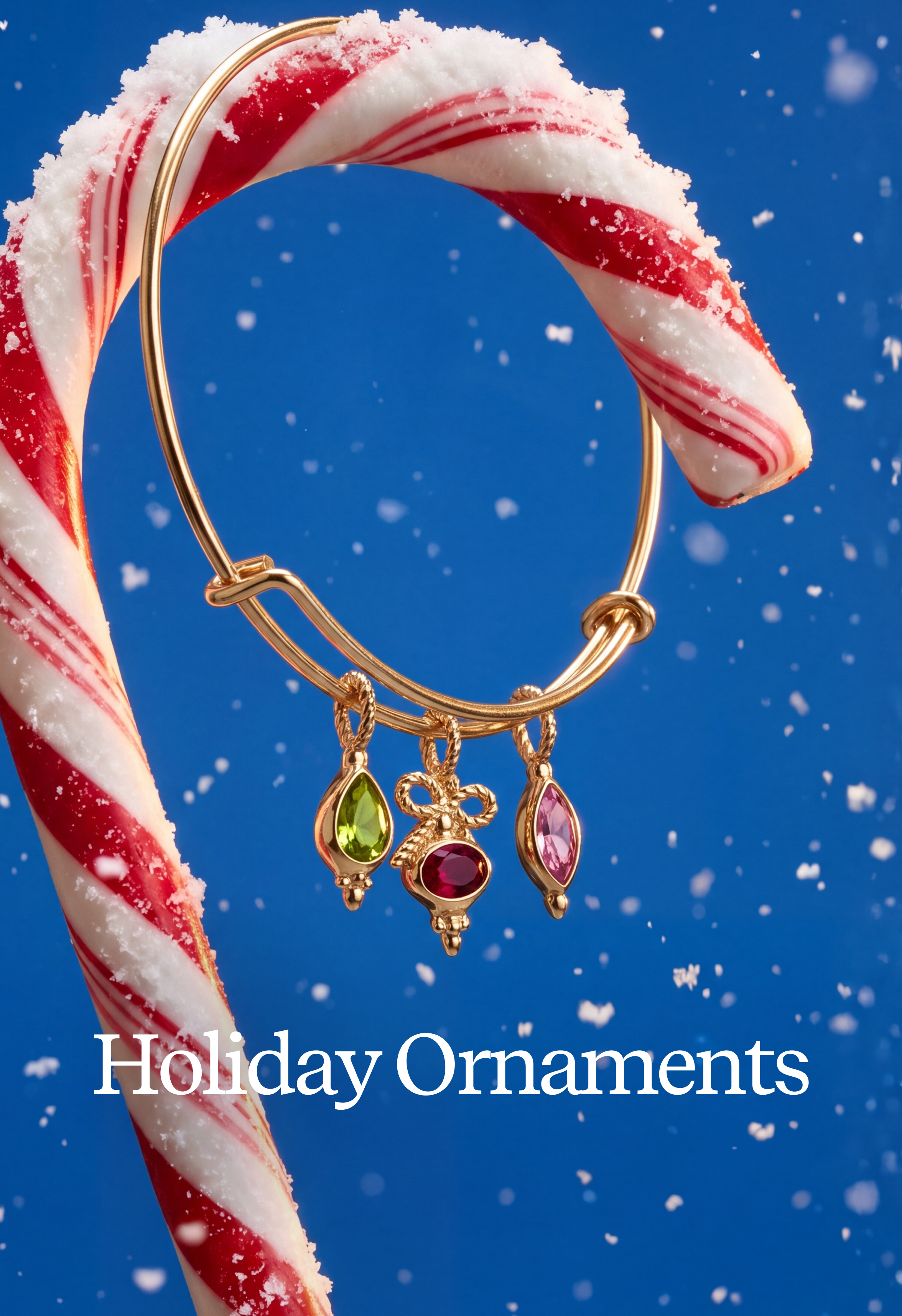 A gold holiday ornament set with three dangling teardrop charms in green, red, and pink, displayed on a large candy cane against a blue snowy background. The text 'Holiday Ornaments' appears at the bottom.