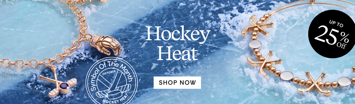 A promotional banner for the 'Hockey Heat' jewelry collection, featuring gold-toned hockey-themed jewelry including a hockey stick pendant, an axe charm, and a hockey stick bracelet, set against a background of ice and water with a 'SHOP NOW' call-to-action and a 'UP TO 25% OFF' badge.