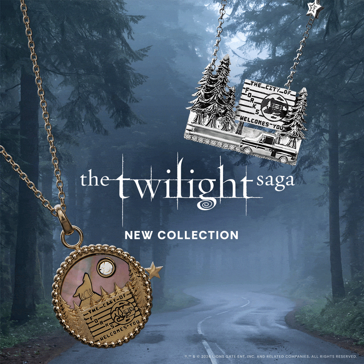Promotional banner for 'The Twilight Saga' jewelry collection, featuring a silver pendant with a moon and stars design on the left and a bronze-toned pendant with a cabin and trees on the right, set against a misty forest road background