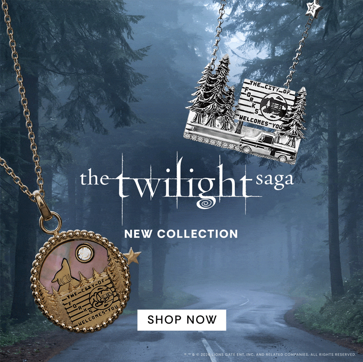 Promotional banner for 'The Twilight Saga' jewelry collection, featuring a silver pendant with a moon and stars design on the left and a bronze-toned pendant with a cabin and trees on the right, set against a misty forest road background with 'SHOP NOW' text 