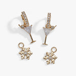 Gold-tone holiday jewelry set featuring a pair of martini glass earrings and two snowflake charms, both adorned with clear rhinestones, displayed on a clean white background.