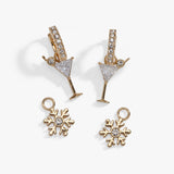 Gold-tone holiday jewelry set featuring a pair of martini glass earrings and two snowflake charms, both adorned with clear rhinestones, displayed on a clean white background.