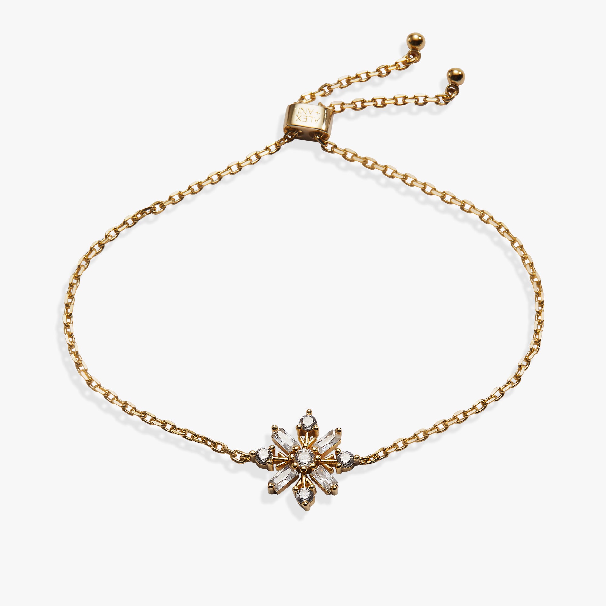 A gold chain bracelet with an adjustable sliding clasp and a central flower-shaped charm set with clear rhinestones, shown on a plain white background.