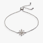 A silver-toned chain bracelet featuring a central snowflake charm set with clear crystals, displayed on a clean white background.