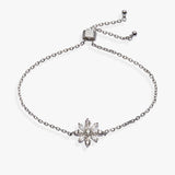 A silver-toned chain bracelet featuring a central snowflake charm set with clear crystals, displayed on a clean white background.