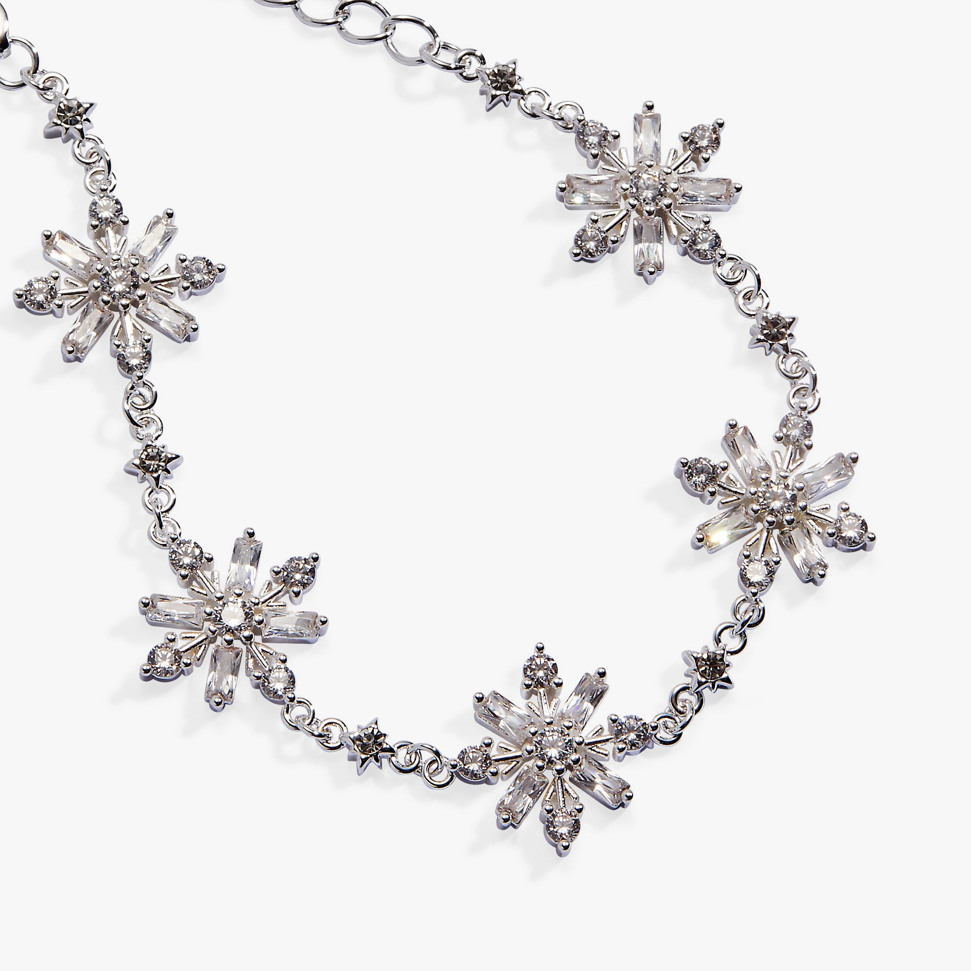 A silver-tone chain necklace featuring five large, clear faceted crystal snowflake motifs spaced along the chain, photographed on a clean white background.