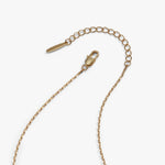 A gold-toned metal chain extender with a lobster clasp and a small branded tag, photographed on a clean white background.
