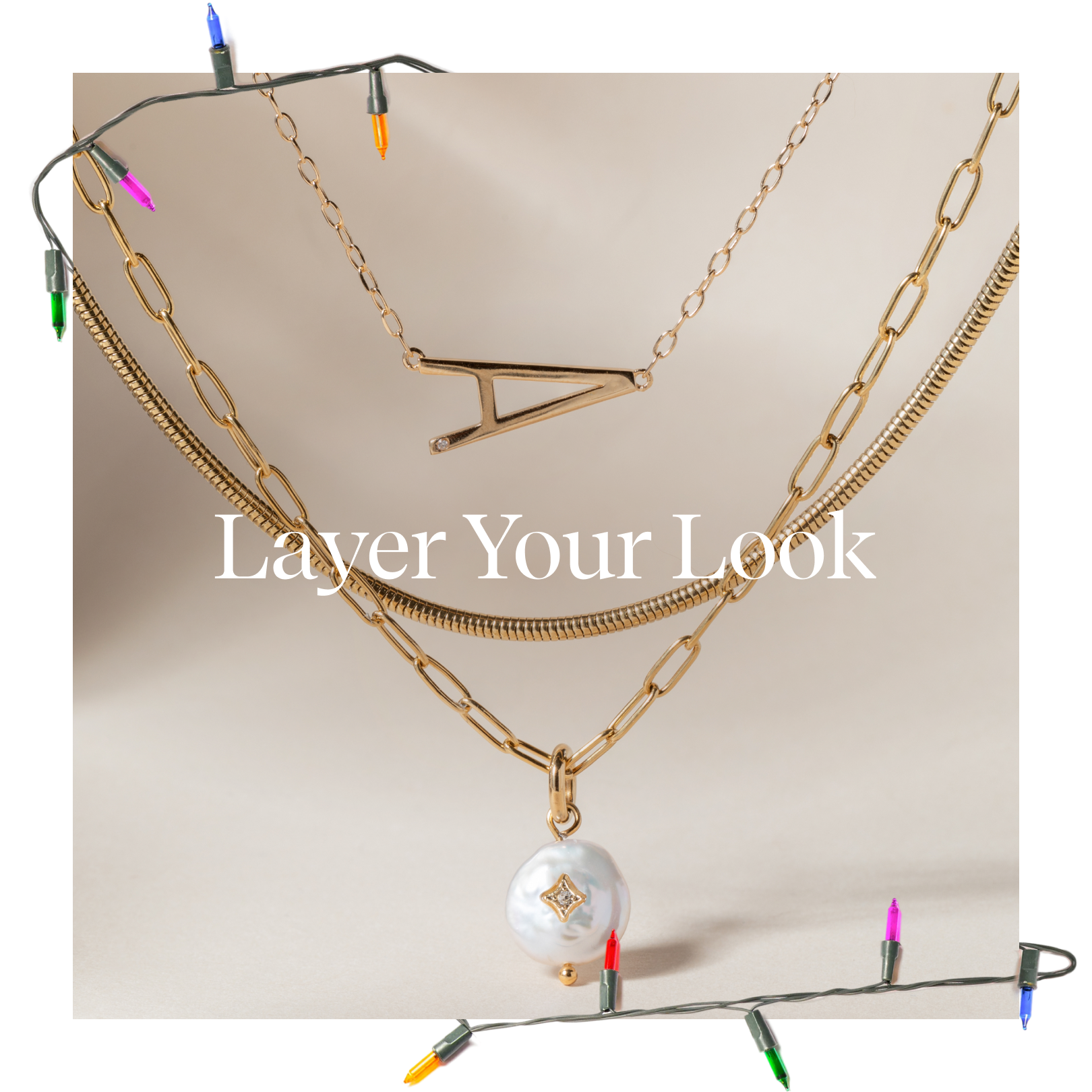 Gold necklaces with a pearl pendant on a beige background with 'Layer Your Look' text.