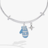 A silver bangle bracelet with a dangling blue and white patterned mitten charm and a small silver star charm, shown on a light gray background.