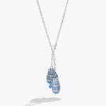 A silver chain necklace featuring a double pendant design shaped like a pair of blue and white patterned knit mittens, shown against a light gray background.