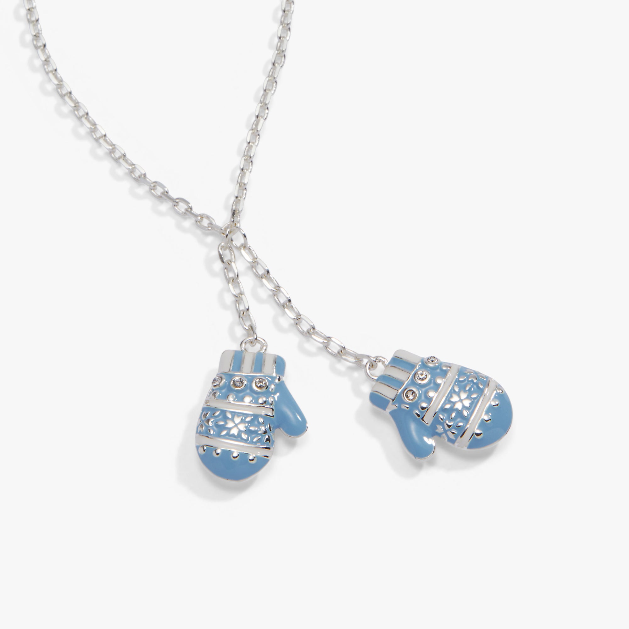 A silver Y-shaped chain necklace featuring two small mitten-shaped charms in light blue with white snowflake patterns and silver accents, shown on a light gray background.