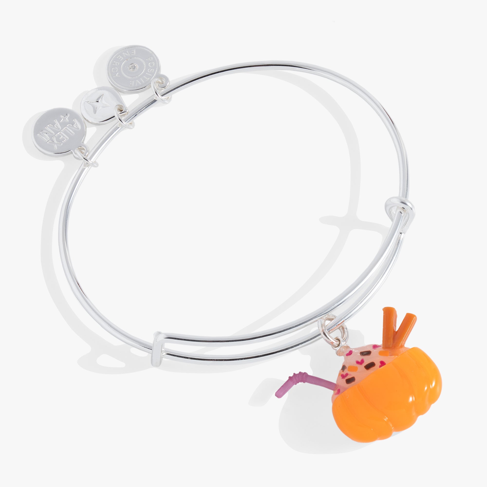 A silver bangle bracelet with a pumpkin shaped latte charm