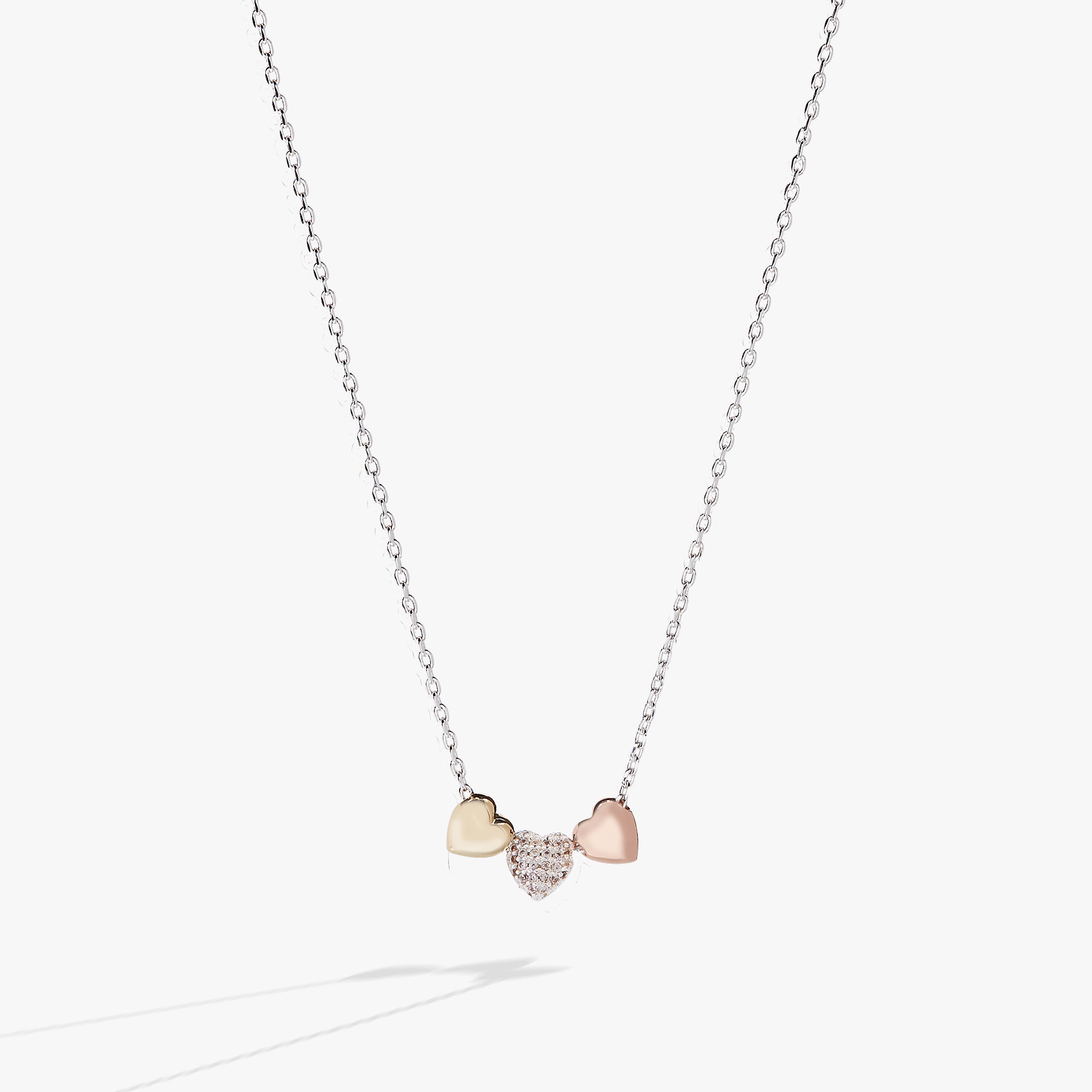 A necklace with three heart charms